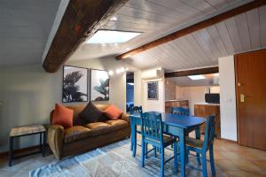 a living room with a couch and a table and chairs at Agriturismo La Filanda in Manerba del Garda