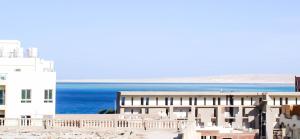 a view of a building and the ocean at Marilyn Studio with Sea View Wi Fi in Hurghada