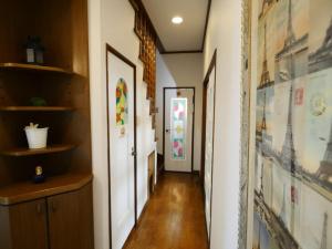 a hallway of a home with paintings on the walls at west crab base in Hiroshima