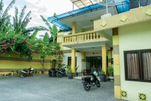 a group of motorcycles parked outside of a building at RedDoorz @ Gatot Subroto Ende in Ende