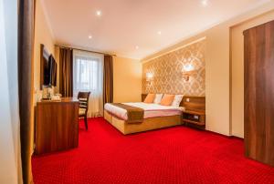 a hotel room with a bed and a desk at BUCUR 9 in Bucharest