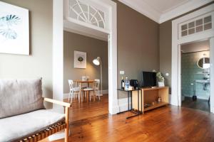 a living room with a couch and a table at Apartamentos com História in Guimarães