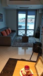 a living room with a couch and a table at Mitilene Harbour Central in Mytilene