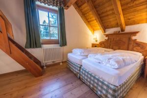 A bed or beds in a room at Rifugio Lago Nambino