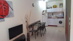 a living room with a table and chairs and a kitchen at Pearl by the Sea, Living room and one bedroom in Ashkelon