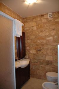 a bathroom with a sink and a toilet at La Mola Maringalli in Cascia