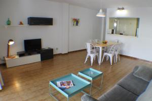 a living room with a couch and a table at Agi Sant Jordi in Roses