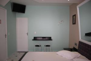 เตียงในห้องที่ Motel Emoções de Guarulhos