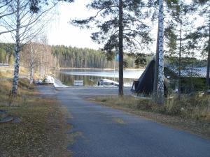 a road with a tent on the side of a lake at Pankkotupa 8B in Punkaharju