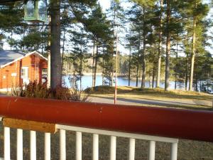 a view of a lake from a fence with a house at Pankkotupa 8B in Punkaharju