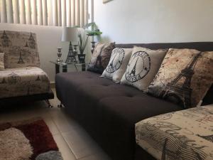 a living room with a couch with pillows on it at Beach Haus-Punta Estrella in Playa del Carmen +45 photos