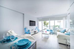 a living room with a couch and a table at Ciudad Blanca Apartment in Port d'Alcudia