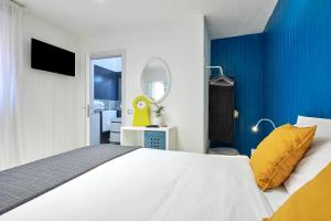 um quarto azul e branco com uma cama e um espelho em Design Suite Cavagna em San Pellegrino Terme