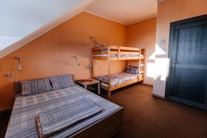a bedroom with two bunk beds and a staircase at Samovar Hostel in Vladimir