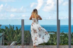 a woman in a white dress looking at the ocean at Hacienda La Dehesa (Only Adults) in Buenavista del Norte +46 photos