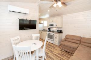 a kitchen and a living room with a table and a couch at Sun Outdoors Ocean City in Ocean City