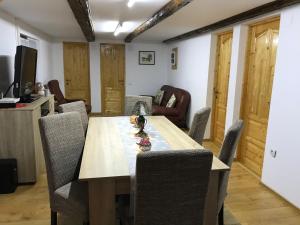 a dining room with a wooden table and chairs at Casa Toma in Avrig