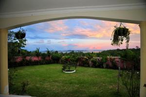 a view of a yard with a view of the sunset at Victoria Lake View Guesthouse & Safaris in Entebbe
