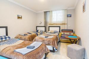 a group of four beds in a room at Guest house poligloti in Telavi