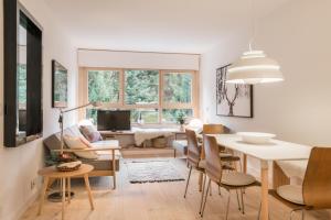 a living room with a table and chairs and a dining room at Airoto by Totiaran in Baqueira-Beret