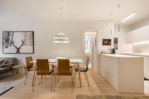 a kitchen and dining room with a table and chairs at Airoto by Totiaran in Baqueira-Beret +20 photos