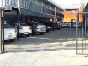 a row of cars parked in a parking lot at Cabañas Isla Teja Sur in Valdivia