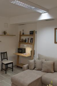 a living room with a couch and a chair at Apartment Anna - FREE pickup from OR dropoff to Zagreb airport, please give three days advance notice - EV station - Long-term parking with airport transport possibility in Velika Gorica