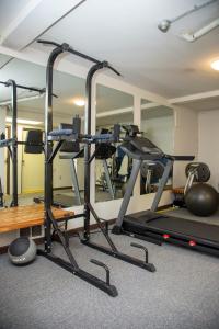 a gym with tread machines and a mirror at Happy Day Inn in Burnaby