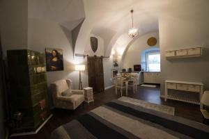 a living room with a table and a chair at Ultra central medieval apartment in Cluj-Napoca