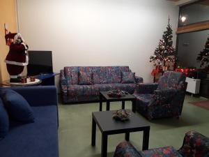 a living room with a couch and a christmas tree at Guest House Dimitrije in Niška Banja