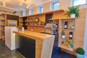 a bar in a room with plants on shelves at Pergola Boutique Hotel in Bucharest
