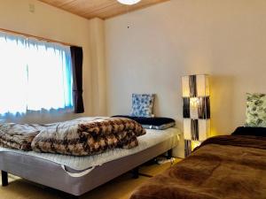 Ένα ή περισσότερα κρεβάτια σε δωμάτιο στο Midtown Sakura Apartment House 201 予約者だけの空間 A space just for you
