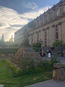 a statue of a woman in front of a building at Hotel Occidental in Guadalajara