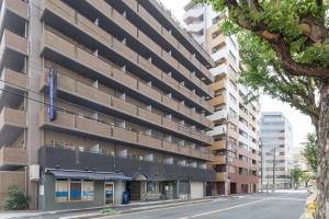 an external view of an apartment building on a street at HOTEL MYSTAYS Otemae in Osaka