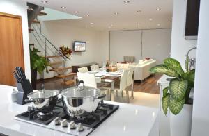 a kitchen and dining room with a table and a stove at Z&R HOME in Huaraz