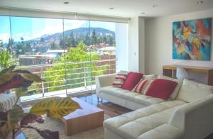 a living room with two couches and a large window at Z&R HOME in Huaraz