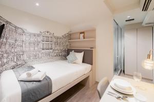 a bedroom with a bed and a desk with a table at Heritage Collection on Chinatown - Mobile App Check-In in Singapore