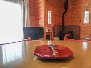 a dining room with a table and a fireplace at Hakuba Powder Cottage Deep in Hakuba