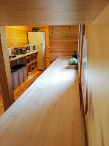a kitchen with wooden floors and a refrigerator at Hakuba Powder Cottage Deep in Hakuba