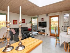 a living room with a couch and a table at Simplistic Holiday Home in Lolland with Terrace in Rødby