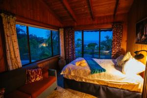a bedroom with a bed and a large window at Marazul Paradise Beach House- Panoramic Ocean Views in Vincentia