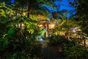 a resort at night with palm trees and a pathway at Marazul Paradise Beach House- Panoramic Ocean Views in Vincentia