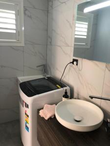 a bathroom with a sink and a toaster at Agapi on Cambridge in Umina