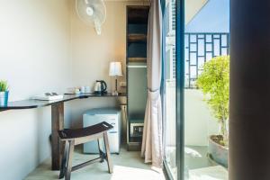 a room with a desk and a chair next to a window at THE BEACH CHA AM Guest House in Cha Am