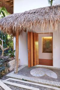 uma pequena casa com um telhado de palha e uma porta em Diniview Villa Resort em Boracay