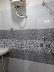 a bathroom with a sink and a shower at No Problem Guest House in Moga