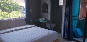 Ein Bett oder Betten in einem Zimmer der Unterkunft Thapae Gate Lodge