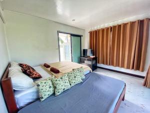 a bedroom with a bed and a large window at Bang Mee Homestay Koh Yao Noi in Ko Yao Noi