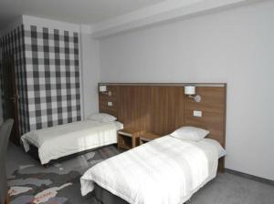 Łóżko lub łóżka w pokoju w obiekcie Hotel Europa