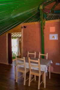 a dining room table and chairs in a house at Playas del Vicario in Las Casas